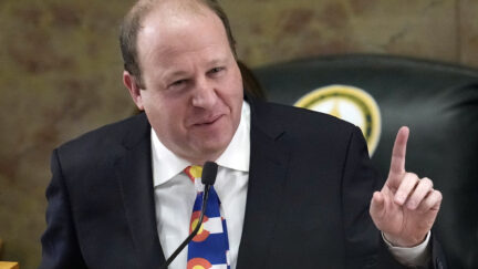 FILE - Colorado Gov. Jared Polis delivers his State of the State address to lawmakers assembled in the House of Representatives chamber in the State Capitol, Tuesday, Jan. 17, 2023, in Denver. Colorado’s governor signed four gun control bills Friday, April 28, 2023, edging the once-purple state closer to liberal-leaning governments in California and New York just months after a shooting at an LGBTQ nightclub in Colorado Springs, the latest in the state’s long history of notorious massacres.