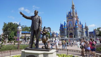 Statue of Walt Disney and Mickey Mouse in front of Cinderella Castle at Walt Disney World in Orlando, Florida.