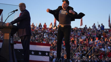 FILE - Elon Musk jumps on the stage as Republican presidential nominee former President Donald Trump speaks at a campaign rally at the Butler Farm Show, Saturday, Oct. 5, 2024, in Butler, Pa.