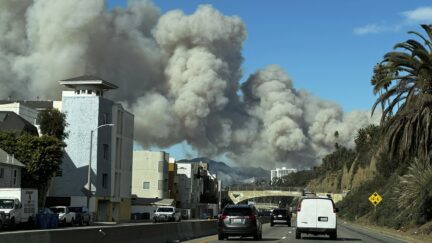 Heavy smoke from a brush fire in the Pacific Palisades rises over the Pacific Coast Highway in Santa Monica, Calif., on Tuesday, Jan. 7, 2025.