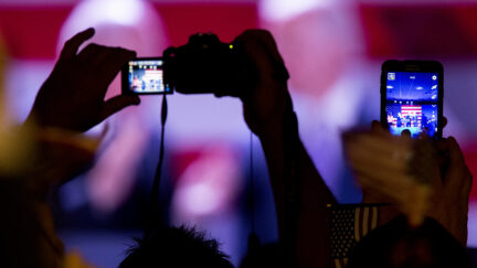 People raise their cameras and phones to take pictures of Vice President Joe Biden.