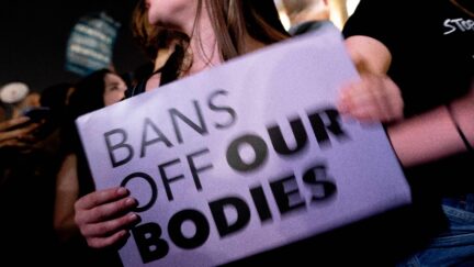 A pro-choice activist holds a sign reading 