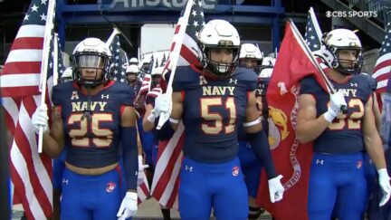 navy football team carry flags onto field to honor 9/11 anniversary